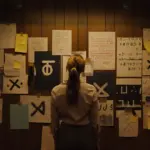 Agent Lee Harker (Maika Monroe) scans the clues in Longlegs.