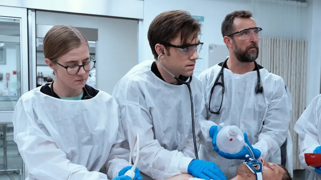 Taylor Deardon, Patrick Ball, and Noah Wyle take care of a patient