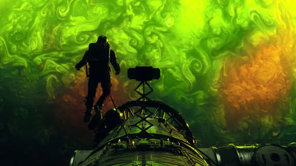Astronaut standing on a spacecraft hull against a green-yellow swirling background, telescope or instrument in foreground.